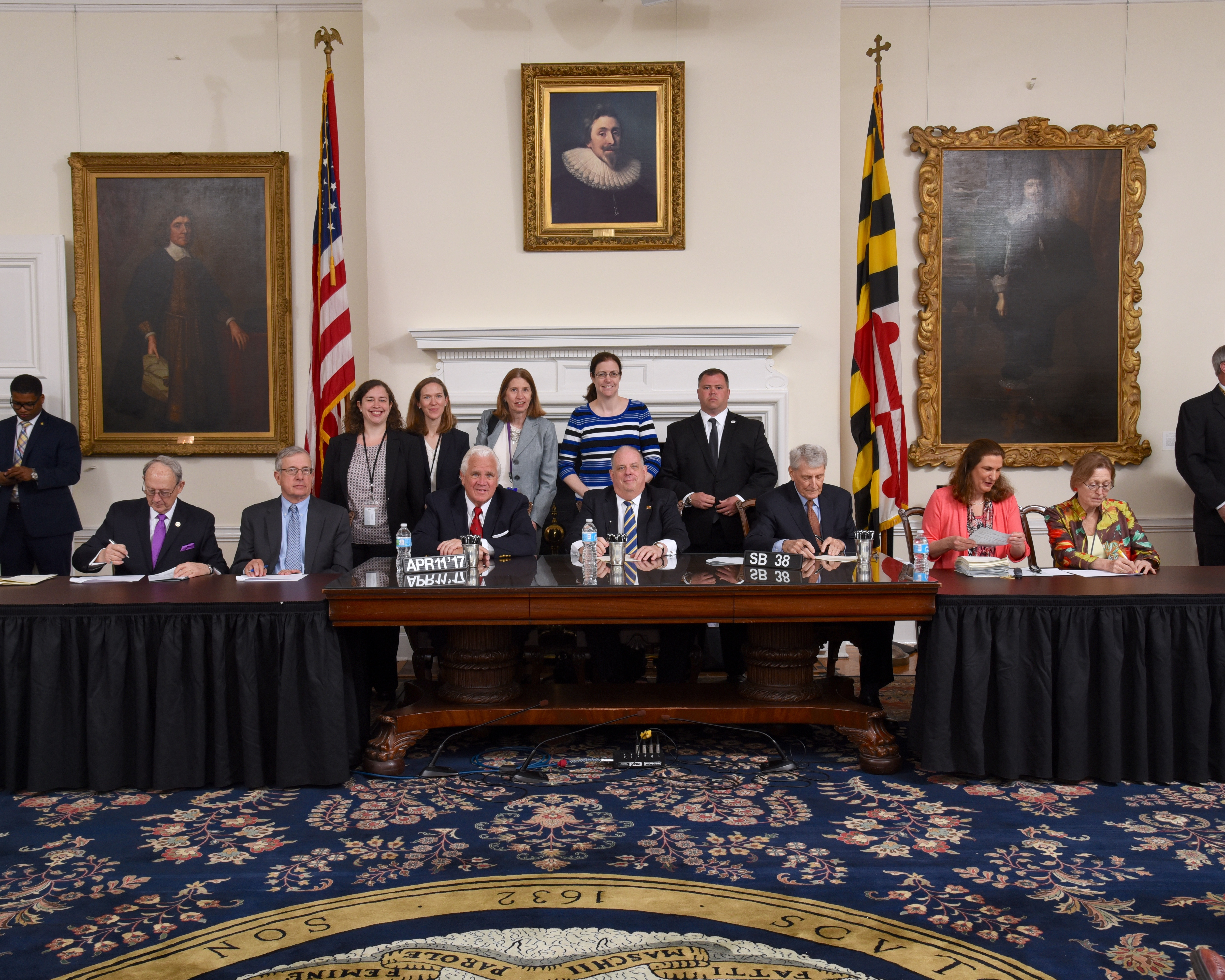 Picture of Governor Hogan signing SB-28 with staff behind him